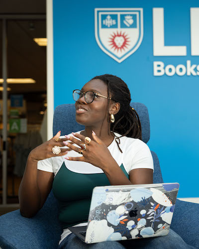 Student mid conversation sitting infant of the bookstore
